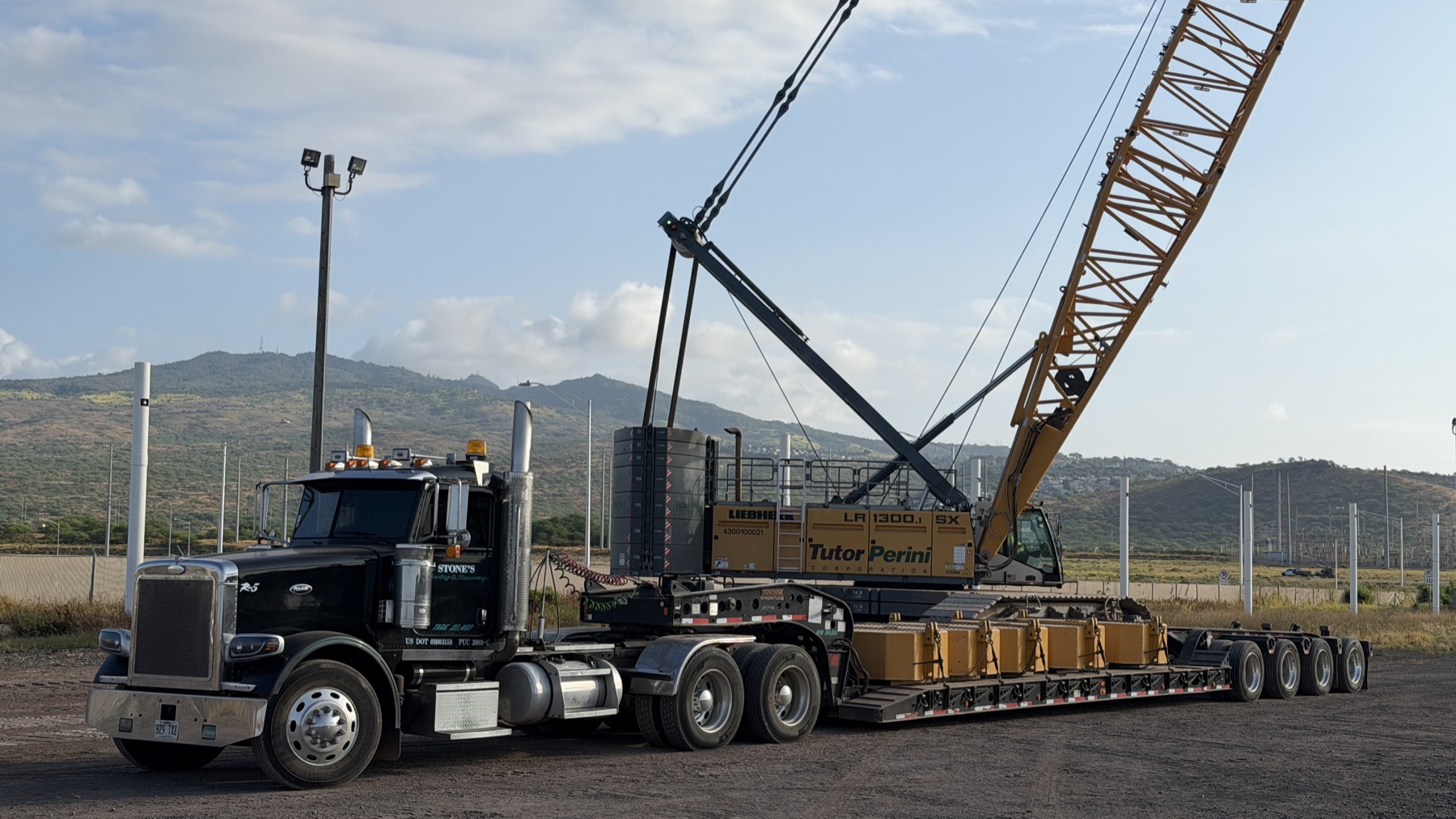 Stone's lowboy trailer hauling a Liebherr crawler crane for Tutor Perini