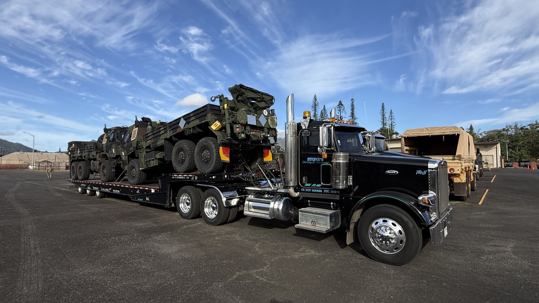 Stone's truck hauling heavy equipment
